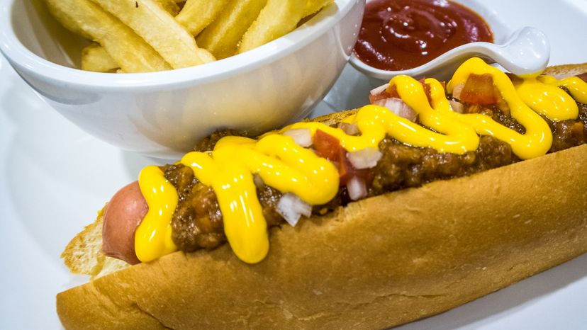 A close up image of a hotdog and chips. 