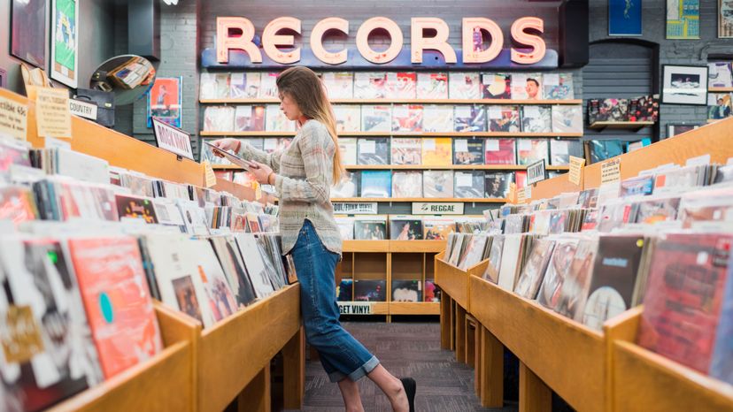 A lady shopping for music records. 