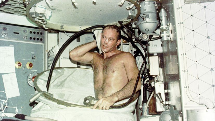 Jack Lousma, Skylab pilot, taking bath