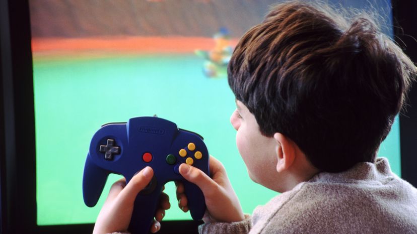 A boy playing a Nintendo game. 