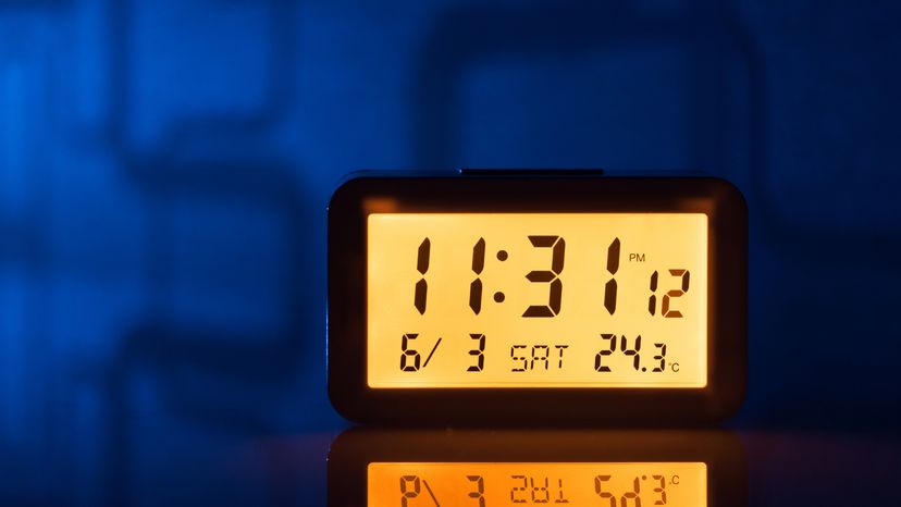 Orange Colored Illuminated Digital Clock at Mid-night.