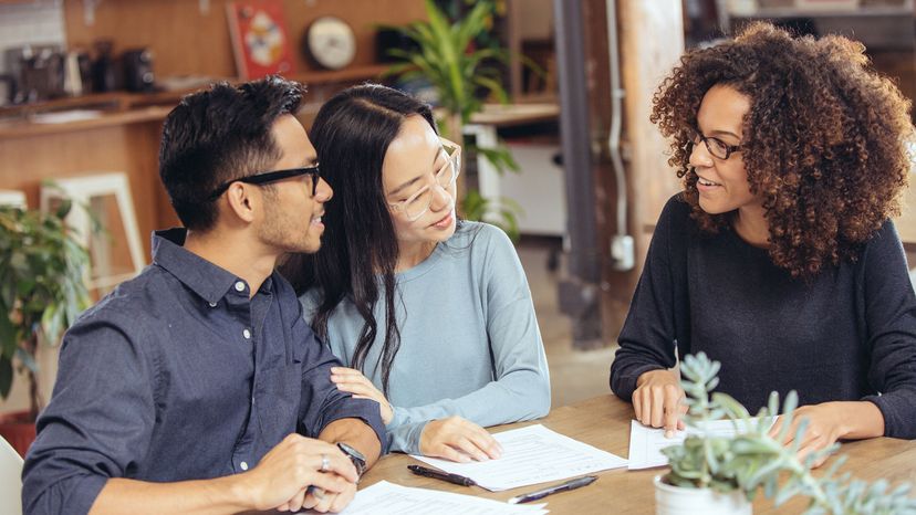 couple looking at loan with lender