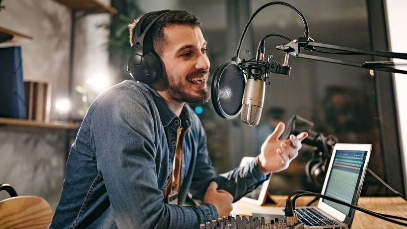 A male radio presenter talking into a microphone