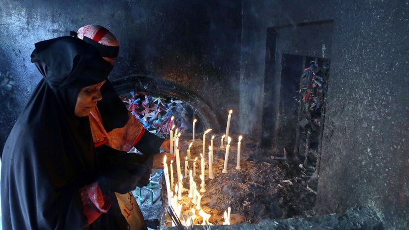 Shia woman in Bangladesh lights candles