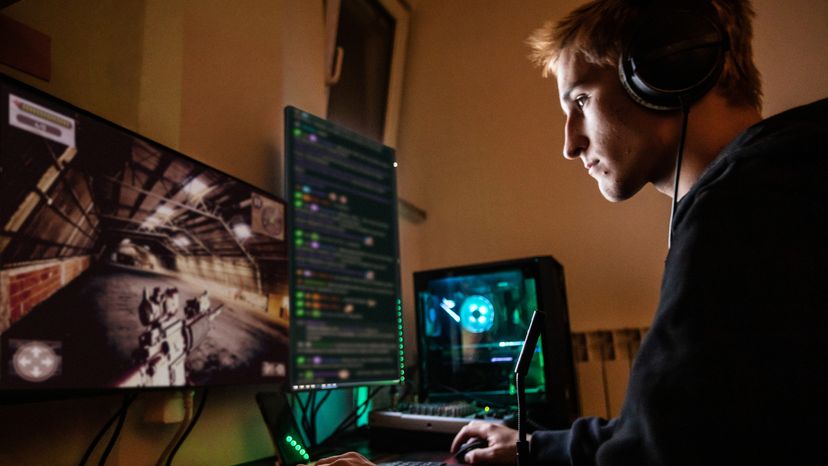 A teenage boy in his room, playing a multiplayer game on his computer.