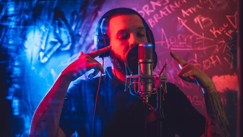 A young man singing in the studio. 