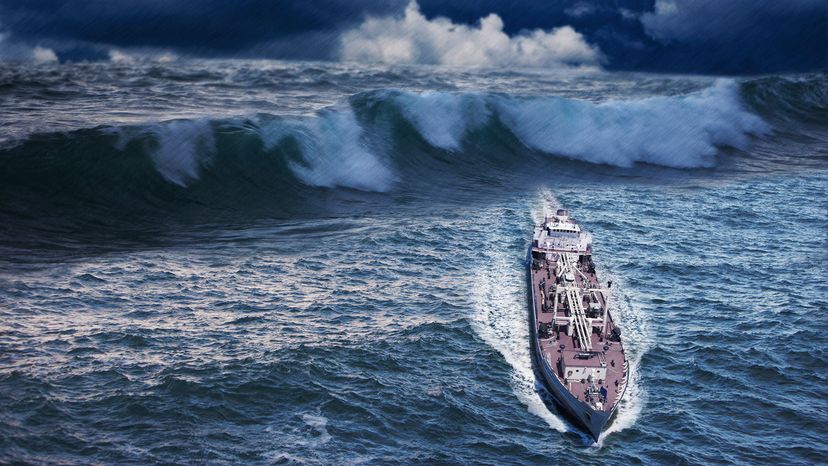 a large ship appears to be just ahead of a large wave