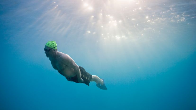 An elderly man underwater. 