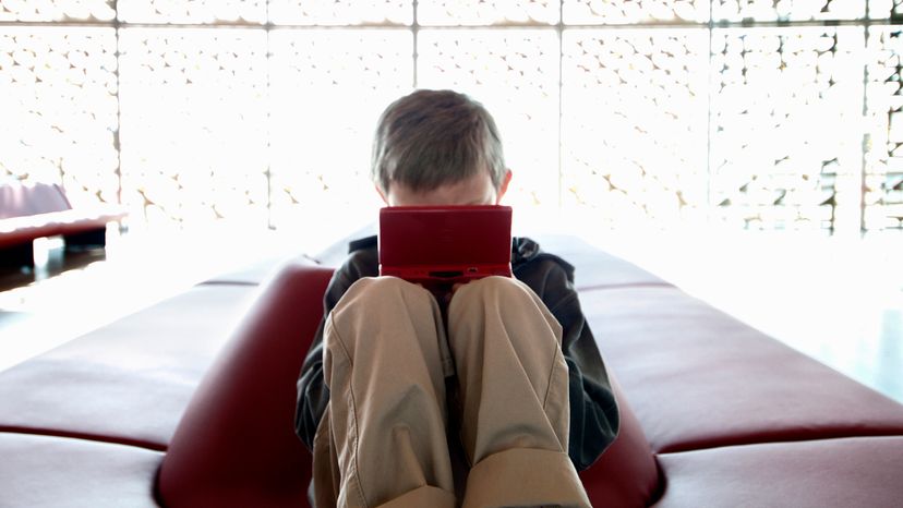 A boy playing with his Nintendo 