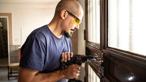 A professional working with a drill. 