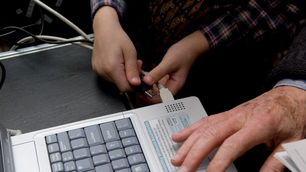 An image showing a hand holding a charger.