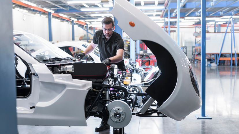 A mechanic working on a new car. 