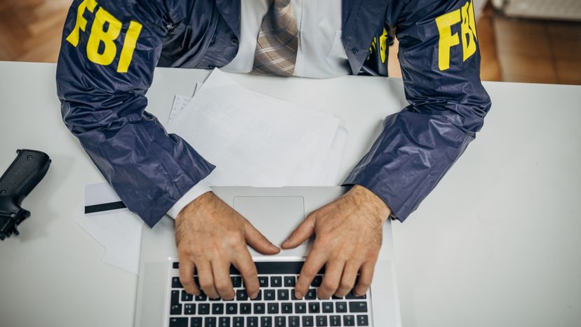 An FBI agent using a laptop. 