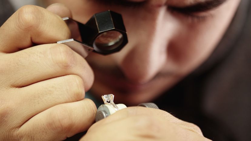 A jeweler repairing a diamond ring. 