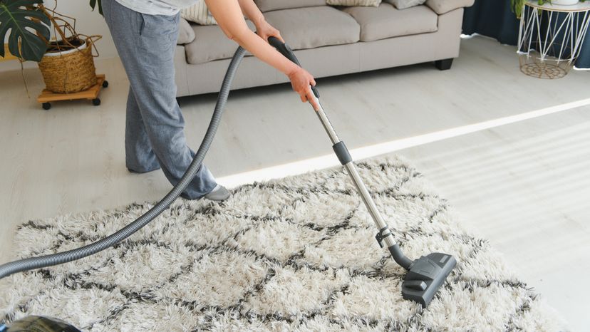 A woman cleaning with an accumulator vacuum cleaner. 