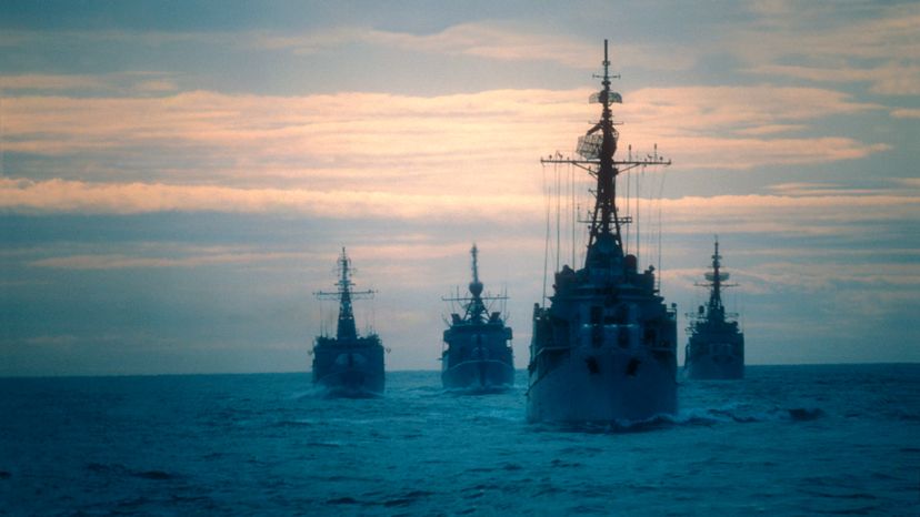 A fleet of battleships on the ocean. 