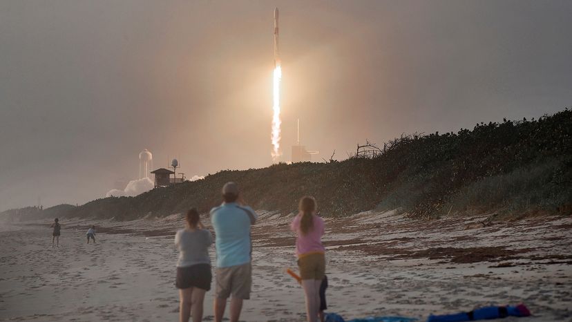 Spectators watch SpaceX Falcon 9 rocket carrying 60 Starlink satellites launch