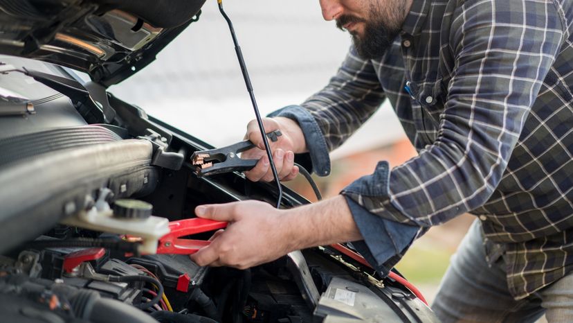 A man checking his car battery. 