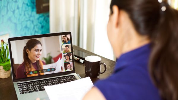 A woman using her laptop for a business video call.