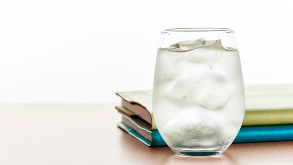 A glass of cold water on a table. 