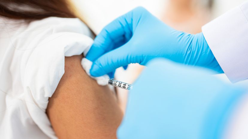 A medical personnel administrating a vaccine. 