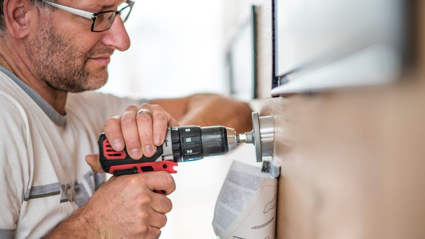 A closeup image of handyman drilling a hole. 