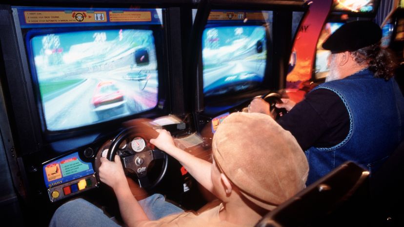 A boy playing a video game at an arcade. 