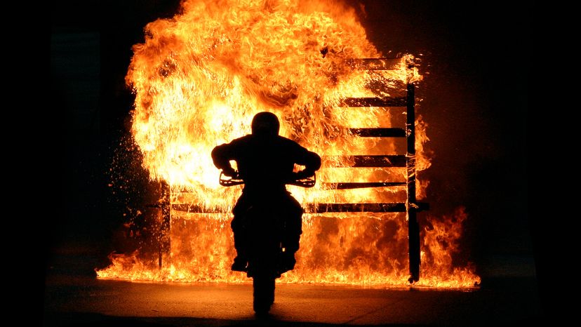 A man riding through a wall of fire 