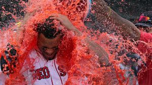 Red Sox player getting drenched by sport drink post-win against New York Yakess