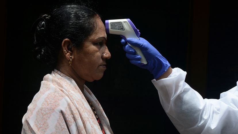 Woman having her temperature checked