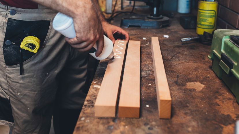 A mans hand working in a furniture factory. 