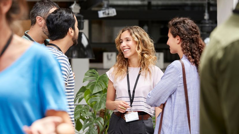 A group of business colleagues having a conversation while standing. 