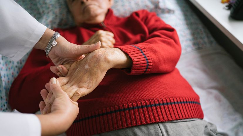 An elderly man with stroke performing physical therapy in his home.