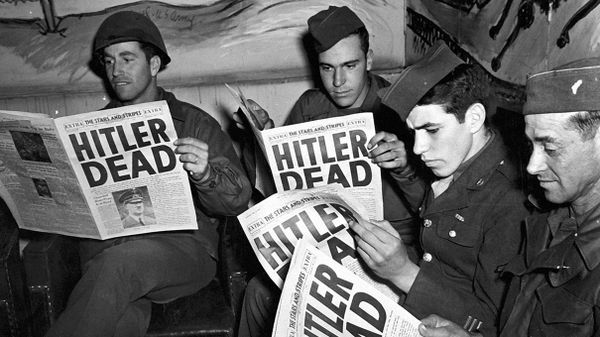 Men holding newspaper editorial sign in black and white.