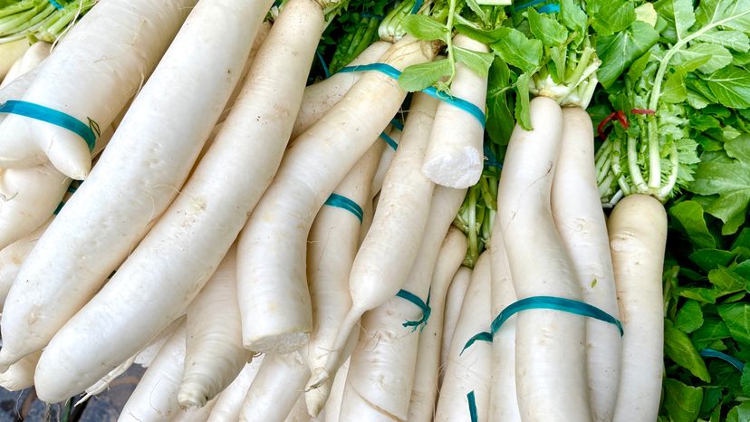 An image of tied up white horseradish. 