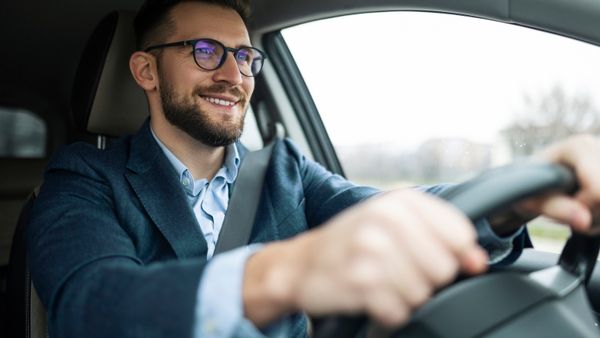 A business man driving his car. 