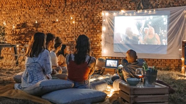 An image of friends having a backyard movie night. 