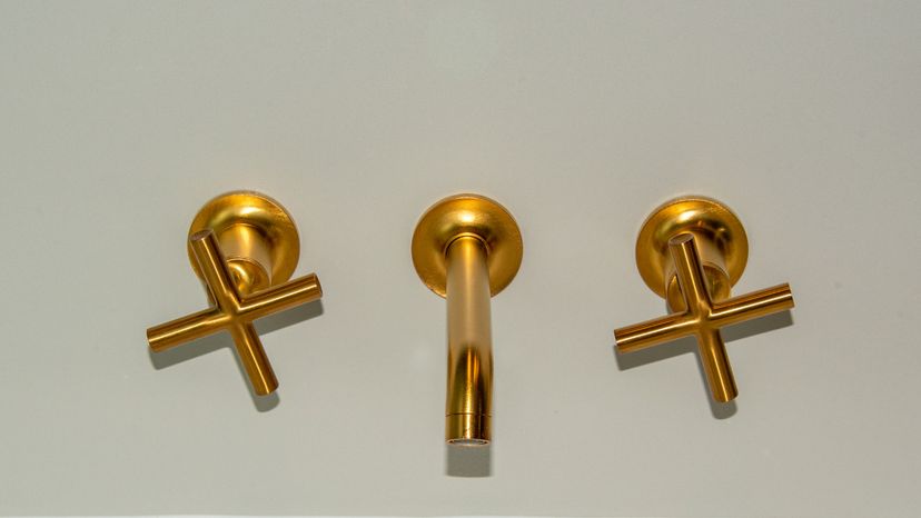 A gold colored faucet. 