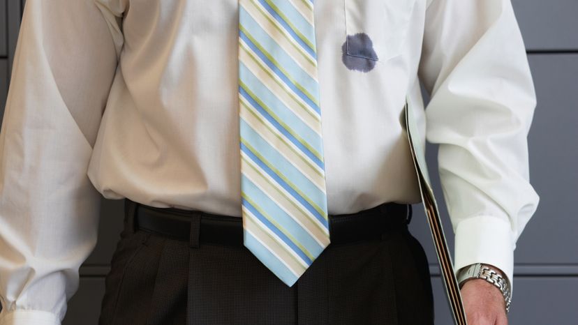 A man wearing a shirt stained with ink. 