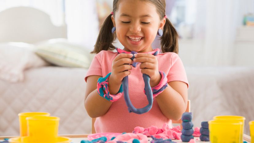 A girl playing dough.