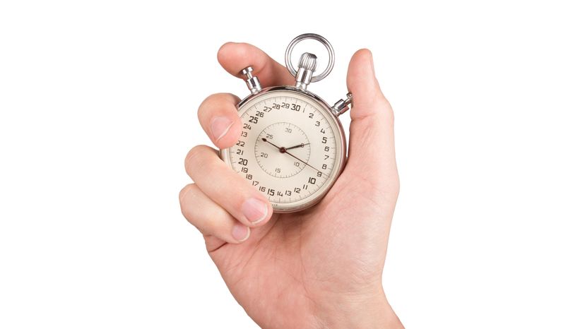 A hand holding a stopwatch.