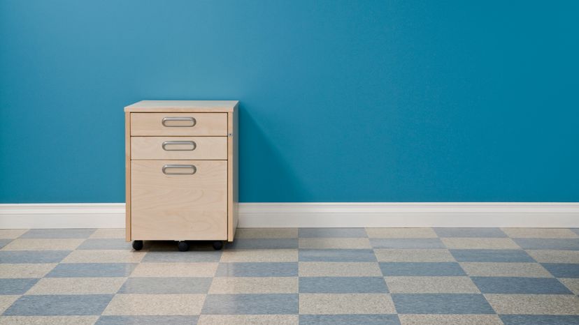 An empty office with a single file cabinet. 