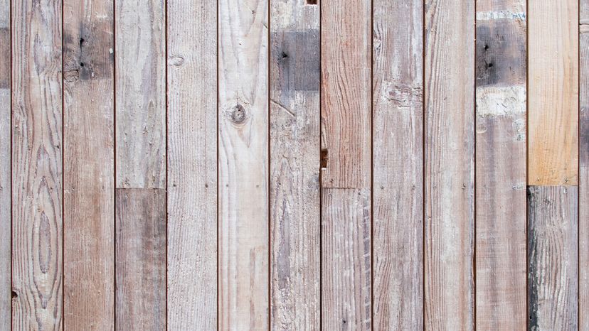 A section of reclaimed wood with different stains and marks from previous use.