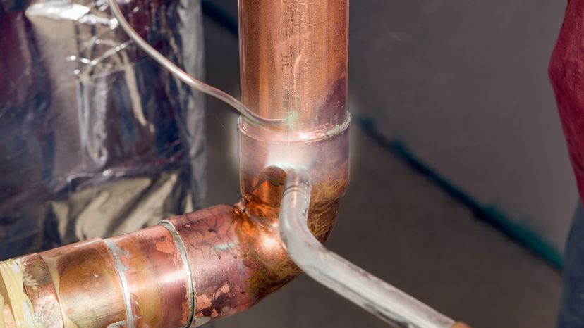 An image of a copper pipes being soled. 