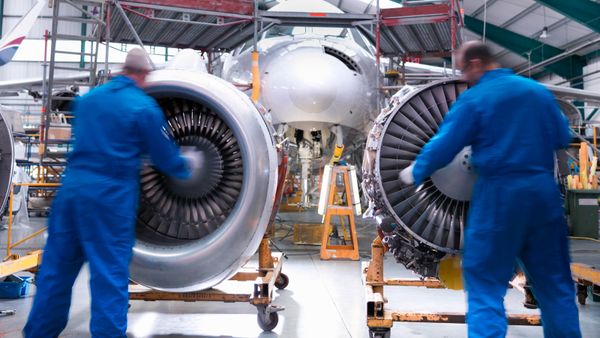 Engineers working on a plane's radial engines. 