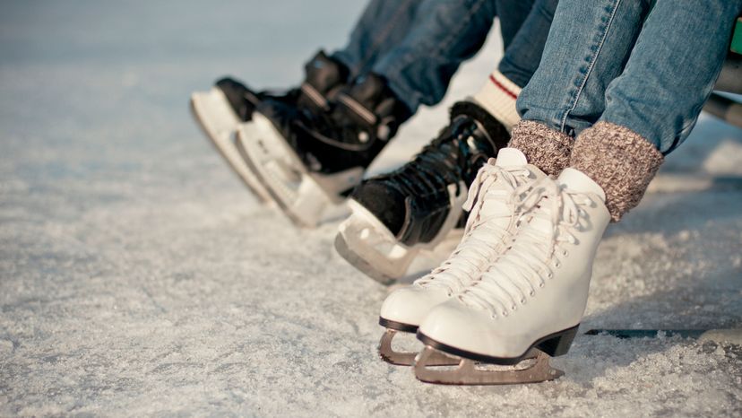 A close up image of three pairs of roller skates on ice. 