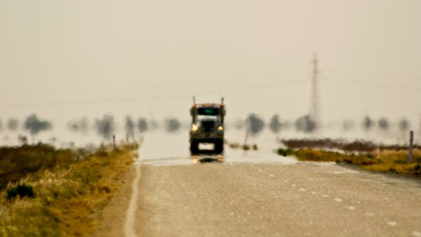 A truck driving down a road.