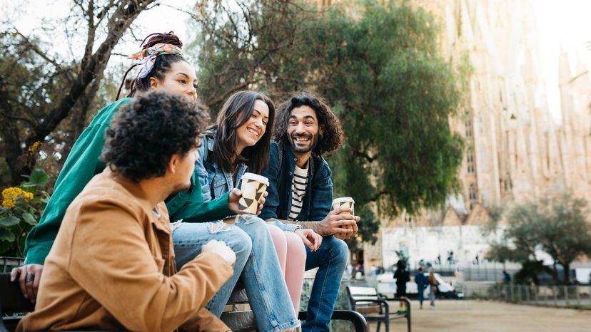 Four female friends taking a selfie at a park. 