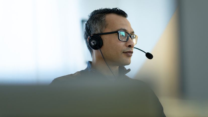 A man wearing a head set to receive calls.