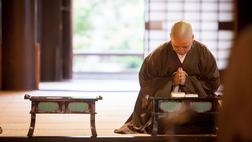 A young monk praying in the temple during his morning ceremony.